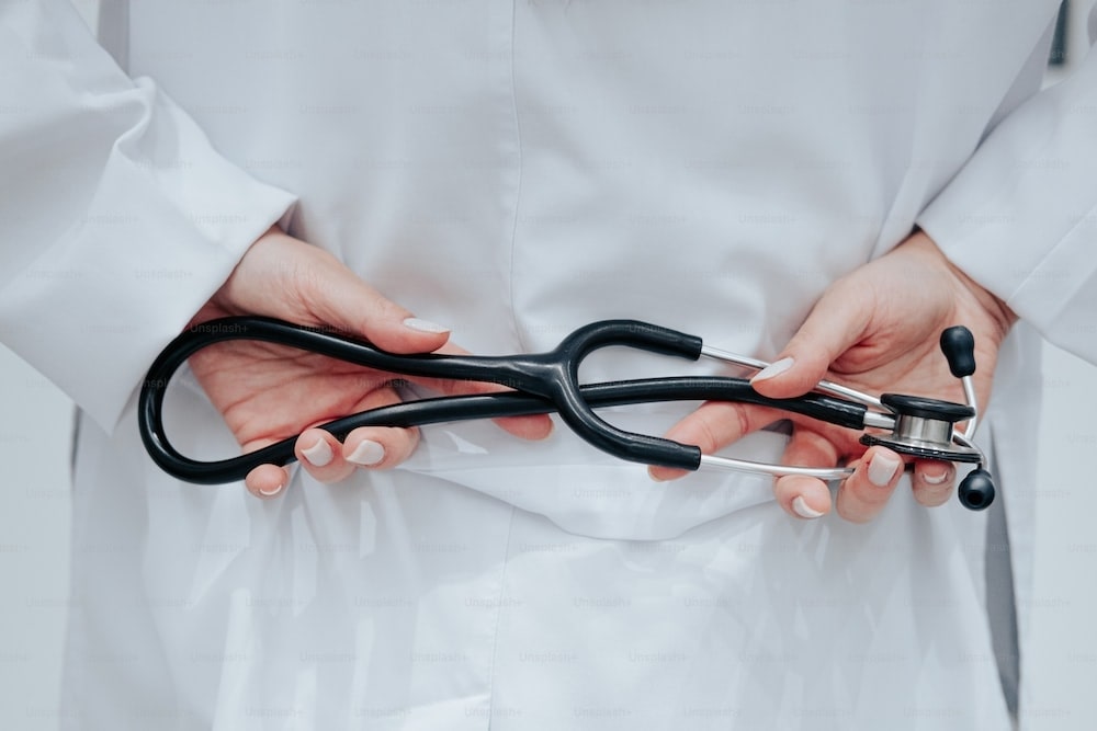 hands holding a stethoscope
