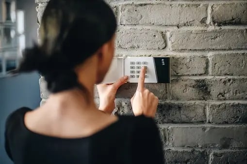 women entering a password in a house lock